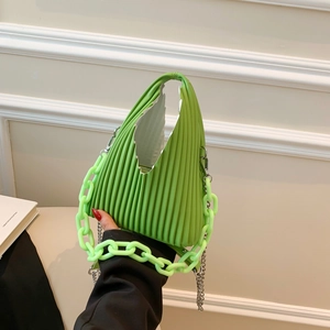 Detail of green pleated PU leather handbag with chunky resin chain and metal strap