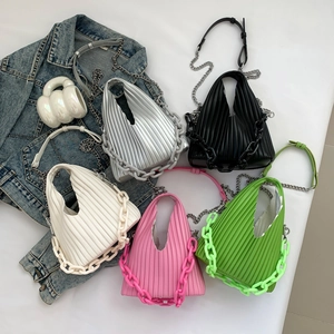 Detail view of colorful pleated crossbody bags with chain straps in silver and white