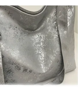 Detail of silver metallic pleated fabric texture showing the soft reflective material