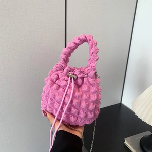 Close-up of vibrant pink bubble pleat bucket bag with silver chain and drawstring closure
