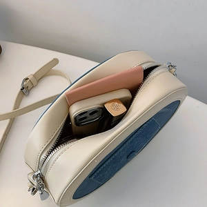 Interior view of small crossbody bag showing space for phone and lipstick
