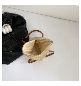Vue détaillée du sac seau en paille montrant la grande capacité avec doublure et fermeture