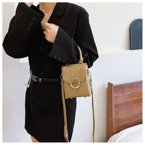 Detail of khaki mini square bag with glossy wrinkled texture and gold D-ring buckle