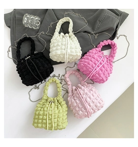 Top view of bubble textured drawstring bucket bags in five vibrant colors with chain straps