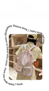 Detail of pink holographic backpack with functional pockets on a model in bookstore