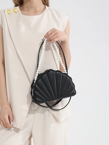 Elegant black shell shaped handbag with pearl handle and slim crossbody shoulder strap