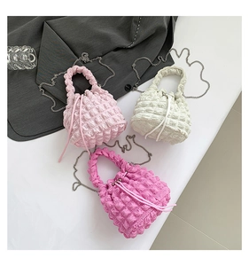 Three textured bubble fabric drawstring bucket bags in pink, beige, and rose red colors
