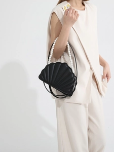 Elegant black shell-shaped handbag with pearl handle and leather strap for women