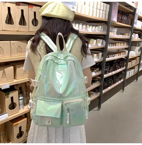 Close-up of laser green backpack showing reflective fabric and adjustable white straps
