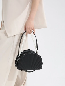 Elegant black shell-shaped handbag with pearl handle and textured faux leather finish