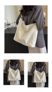 Detail of a creamy white bucket bag featuring a decorative lace bow and smooth texture