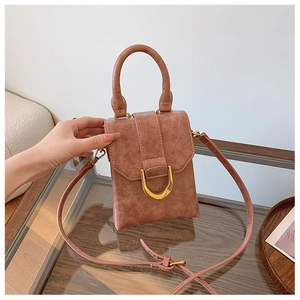 Detailed view of retro faux leather mini bag with gold D-ring and crackle texture