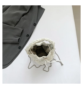 Top view of off-white pleated cloud bucket bag with silver metal chain strap