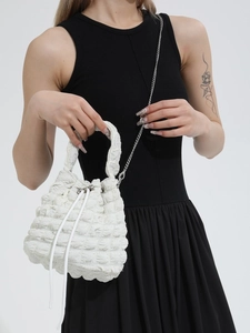 White ruched cloud bucket bag with bubble texture and silver metal chain strap