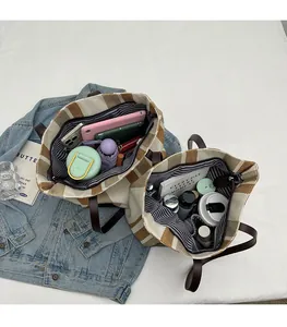 Top view of spacious checkered tote bag interior with tablet and daily essentials