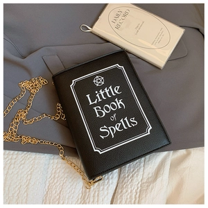 Detail of Little Book of Spells pattern and lychee texture on black PU crossbody bag