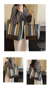 Detail view of large and medium striped canvas tote bags with leather straps and silver studs