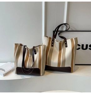 Detailed comparison of large and small striped canvas tote bags with leather straps