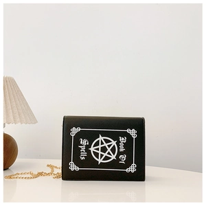 Close-up of gothic Book of Spells pattern and star detail on black punk style crossbody bag
