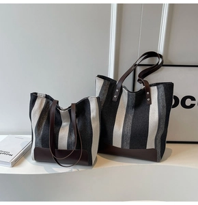 Detailed comparison of large and small striped canvas tote bags with leather handles