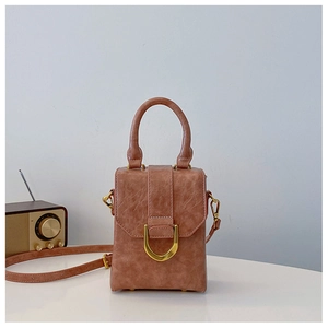Detail of vintage dusty rose mini handbag with elegant gold U-shaped metal buckle buckle