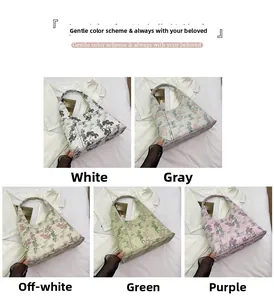 Detail showing five colors of Chinese style embroidered tote bags on textured background