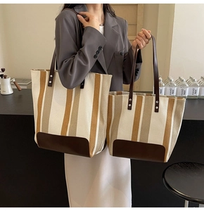 Detailed set of canvas tote bags in contrasting vertical stripes with leather trim
