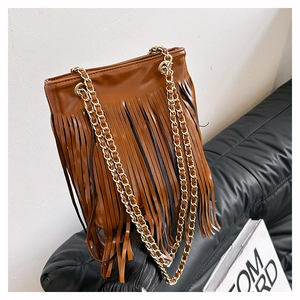 Vue détaillée du sac à main marron caramel avec de longues franges en cuir et chaînes dorées