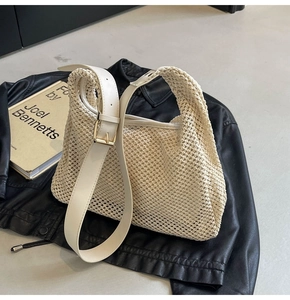 Close-up of beige woven texture with white leather strap and gold buckle detail