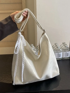 Minimalist beige bucket bag with lace ribbon and shiny leather texture for women