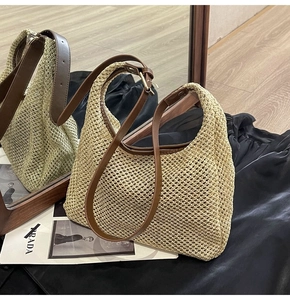 Detail of the beige woven hobo bag showing the hollow mesh texture and brown leather strap