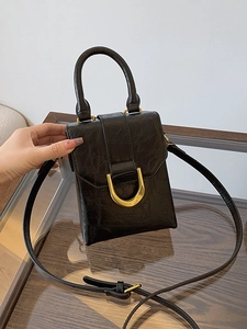 Black vintage textured mini handbag with gold metal clasp and adjustable shoulder strap