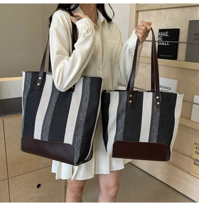 Size comparison of striped canvas tote bags with leather trim and metal rivets on bottom