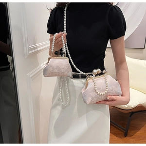 Detail of floral brocade embroidery and dual pearl straps on vintage evening bag