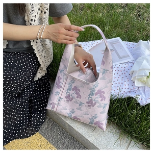 Detail of a pink floral hobo bag with traditional Chinese embroidery and matching coin purse