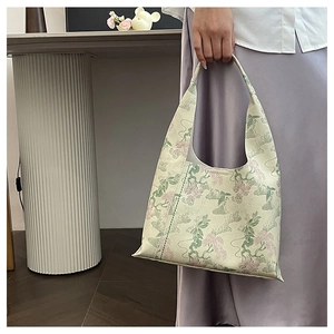 Detail of floral jacquard tote bag with embroidery, paired with a stylish purple dress