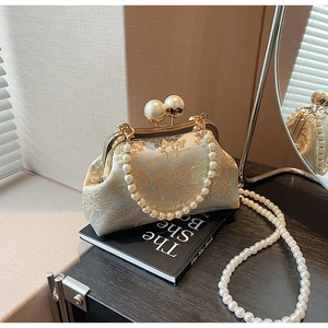 Detailed macro of vintage beige floral jacquard fabric with elegant pearl clasp