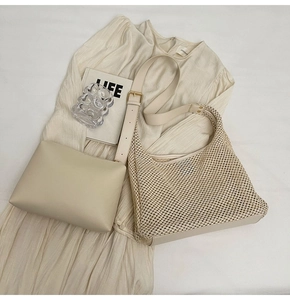 Detail view of cream woven tote bag set with inner leather pouch and mesh texture