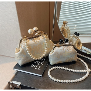 Detail view of vintage Chinese style embroidered bags with pearl handles and gold embroidery