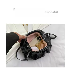 Internal view of black cloud bag showing large capacity for phone and cosmetics