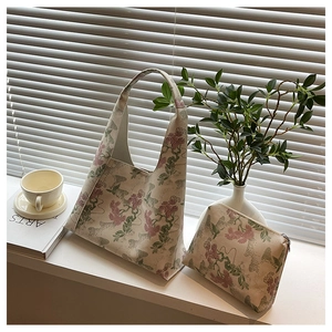 Close-up of vintage floral tote bag and matching pouch by bright sunlit window