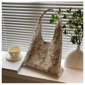 Detail of embroidered floral patterns on a retro Chinese style large hobo bucket bag