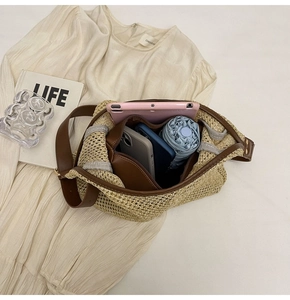 Top view of straw woven bag showing spacious interior with tablet, phone and umbrella