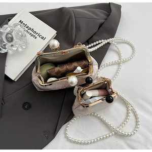 Detail view of retro embroidery handbag featuring pearl clasp and elegant jacquard fabric