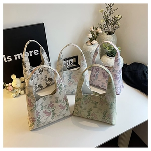 Detailed macro view of five vintage floral embroidered tote bags with sturdy fabric handles