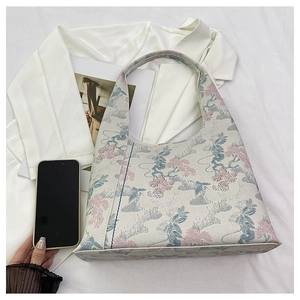 Detail of embroidered crane and pine tree patterns on vintage jacquard shoulder bag
