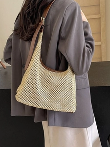 Chic beige woven straw half-moon shoulder bag with brown leather strap for summer beach trips