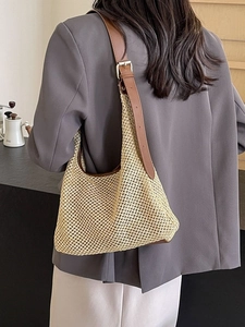 Women's woven straw hobo bag with leather straps for beach holidays and summer travel