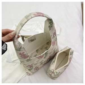 Detail view of floral canvas tote bag with magnetic clasp and matching zipper pouch
