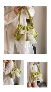 Detail view of corduroy texture and white chiffon bow on the green shoulder bag